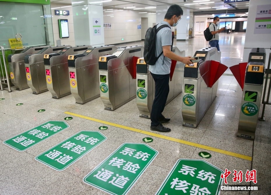 北京地下鉄七里莊駅で、乗車QRコードをかざして改札を通る乗客（6月9日撮影?易海菲）。